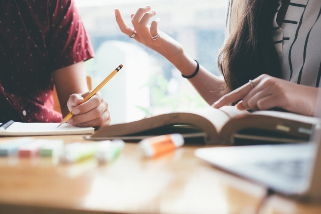 Young students campus helps friend catching up and learning