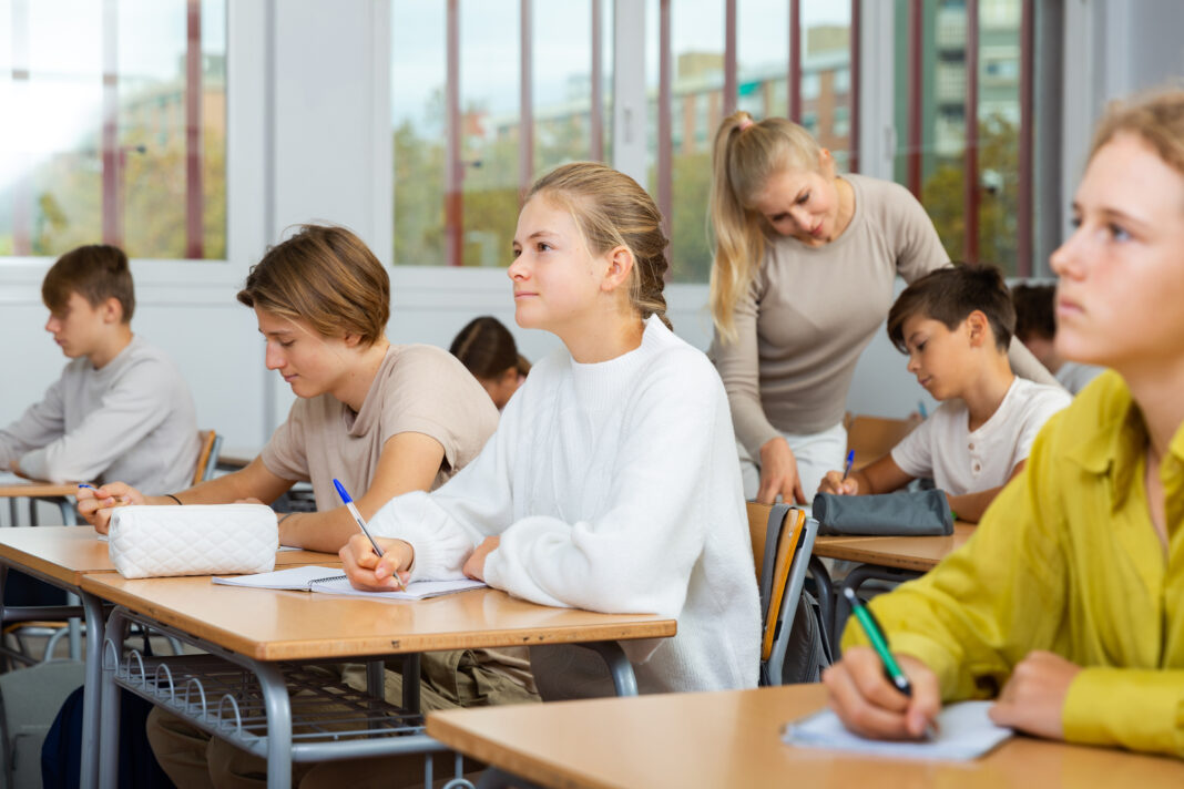 Student is sitting test and answer about task in classroom.